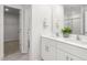 Bright bathroom with dual sinks, a large mirror, and a view of the walk-in closet at 2739 Luxborough Ln, Mebane, NC 27302
