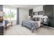 bedroom featuring a bed with plaid bedding, stylish decor, and a large window at 2739 Luxborough Ln, Mebane, NC 27302