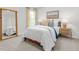 Comfortable bedroom featuring a bed, nightstand with lamps, and a framed mirror at 2739 Luxborough Ln, Mebane, NC 27302