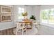 Bright dining area features a round wooden table, seating for four, and modern decor at 2739 Luxborough Ln, Mebane, NC 27302