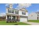Two-story home with a brick and siding exterior, a two-car garage, and a well-maintained lawn at 2739 Luxborough Ln, Mebane, NC 27302