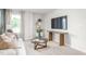 Comfortable living room features a couch, tv, book shelf, and lots of natural light at 2739 Luxborough Ln, Mebane, NC 27302