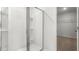 Modern shower with glass doors and built-in shelving, next to a walk-in closet at 2739 Luxborough Ln, Mebane, NC 27302