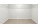 Unfurnished walk-in closet featuring carpeted floors and shelving with hanging racks at 2739 Luxborough Ln, Mebane, NC 27302