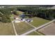 Aerial view of a property with pond, barn, horse ring, outbuildings, and house at 2747 Beasley, Benson, NC 27504