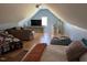 Cozy upstairs bedroom featuring sloped ceilings, comfortable seating, and multiple beds for guests at 2747 Beasley, Benson, NC 27504