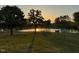 Lovely backyard with green grass, trees, and a calming pond view, perfect for relaxation and recreation at 2747 Beasley, Benson, NC 27504