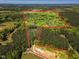 Expansive aerial view of acreage, highlighting the lot's mature trees and potential for development at 2784 Norrington Rd, Lillington, NC 27546