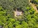 Aerial view of property highlighting the privacy afforded by mature trees surrounding home at 2784 Norrington Rd, Lillington, NC 27546