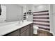 Bathroom with vanity, stainless steel faucet, and a striped shower curtain at 2784 Norrington Rd, Lillington, NC 27546