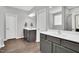 Bathroom with dual vanity sinks, wood cabinets, white countertops and a large mirror at 2784 Norrington Rd, Lillington, NC 27546
