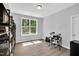 Bedroom featuring hard wood floors, a large window with natural light and a drumset at 2784 Norrington Rd, Lillington, NC 27546