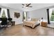 Bright bedroom with natural light, ceiling fan, wood accent decor and computer setup at 2784 Norrington Rd, Lillington, NC 27546