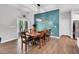 Elegant dining room with a large wooden table and stylish light fixture at 2784 Norrington Rd, Lillington, NC 27546