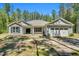 Charming single-story home with stone accents, blue shutters, and attached two car garage at 2784 Norrington Rd, Lillington, NC 27546