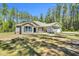 Charming single-story home with stone accents, blue shutters and a well-manicured lawn at 2784 Norrington Rd, Lillington, NC 27546