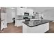 Modern kitchen with white cabinets, black countertops, and stainless steel appliances at 2784 Norrington Rd, Lillington, NC 27546