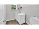 Bright laundry room with a washer and dryer, utility sink, and shelving at 2784 Norrington Rd, Lillington, NC 27546