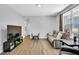 Well-lit living room with wood-look floors and comfortable gray seating at 2784 Norrington Rd, Lillington, NC 27546