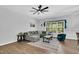 Inviting living room featuring wood-look floors, comfortable seating, and large window at 2784 Norrington Rd, Lillington, NC 27546