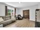 Cozy living room with wood-look floors, comfortable seating, and natural light at 2784 Norrington Rd, Lillington, NC 27546