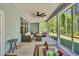 Screened porch with ceiling fan and comfortable seating overlooking the yard at 2784 Norrington Rd, Lillington, NC 27546
