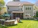 Spacious backyard with stone barbecue and a covered patio with outdoor furniture at 2817 Peachleaf St, Raleigh, NC 27614