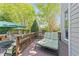 Cozy backyard deck with cushioned chaise lounge, patio furniture, and a green umbrella at 2817 Peachleaf St, Raleigh, NC 27614