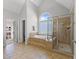 This bathroom is equipped with a soaking tub, tiled shower, and a neutral color scheme at 2817 Peachleaf St, Raleigh, NC 27614