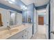 Well-lit bathroom features double sinks and access to the bedroom in view at 2817 Peachleaf St, Raleigh, NC 27614