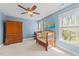 Bright bedroom with blue walls, wood furniture and lots of natural light at 2817 Peachleaf St, Raleigh, NC 27614