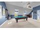 Spacious game room features billiard table, ample natural light and blue accent wall at 2817 Peachleaf St, Raleigh, NC 27614
