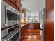 Stylish kitchen with stainless steel appliances, wooden cabinets, tile backsplash, and hardwood flooring at 2817 Peachleaf St, Raleigh, NC 27614