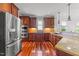 Gourmet kitchen with stainless steel appliances, custom cabinets, hardwood floors, and granite countertops at 2817 Peachleaf St, Raleigh, NC 27614