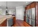 Open kitchen layout with stainless steel appliances, custom cabinetry, and an adjacent breakfast bar area at 2817 Peachleaf St, Raleigh, NC 27614