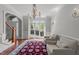 Bright living area featuring hardwood floors, large windows, two chairs and chandelier at 2817 Peachleaf St, Raleigh, NC 27614