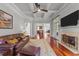 Open concept living room featuring a fireplace, coffered ceiling and hardwood floors at 2817 Peachleaf St, Raleigh, NC 27614