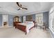 This large main bedroom offers neutral carpet and a large window overlooking a private backyard at 2817 Peachleaf St, Raleigh, NC 27614