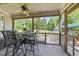 Covered patio with table, chairs, ceiling fan, and screened view of the backyard at 2817 Peachleaf St, Raleigh, NC 27614