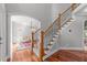 Classic staircase with wooden handrail, carpeted steps, and detailed wrought iron spindles at 2817 Peachleaf St, Raleigh, NC 27614
