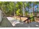 Large wooden deck overlooking a tranquil wooded backyard setting at 313 Crown Oaks Dr, Raleigh, NC 27615