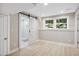 Finished basement with sliding barn door leading to a tiled shower at 313 Crown Oaks Dr, Raleigh, NC 27615