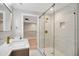 Bright bathroom showcasing a glass shower with gold fixtures and marble floors at 313 Crown Oaks Dr, Raleigh, NC 27615