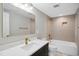 Bathroom with marble countertop, brass fixtures, and tiled shower at 313 Crown Oaks Dr, Raleigh, NC 27615