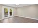 Bright room with hardwood floors and glass doors leading to an outdoor deck with wooded views at 313 Crown Oaks Dr, Raleigh, NC 27615