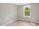 Neutral bedroom with window showing the home across the street at 313 Crown Oaks Dr, Raleigh, NC 27615