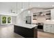 Modern kitchen featuring an island with a marble countertop, pendant lighting, stainless appliances, and hardwood floors at 313 Crown Oaks Dr, Raleigh, NC 27615