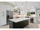 Bright kitchen with stainless appliances, an island with marble countertop, pendant lights, and hardwood floors at 313 Crown Oaks Dr, Raleigh, NC 27615