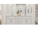 Bright bathroom showcasing double sink vanity with white cabinets and modern silver hardware at 320 Canyon Spring Trl, Wake Forest, NC 27587