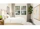 Calm main bedroom with neutral tones, large window, curtains, plants, and natural light at 320 Canyon Spring Trl, Wake Forest, NC 27587